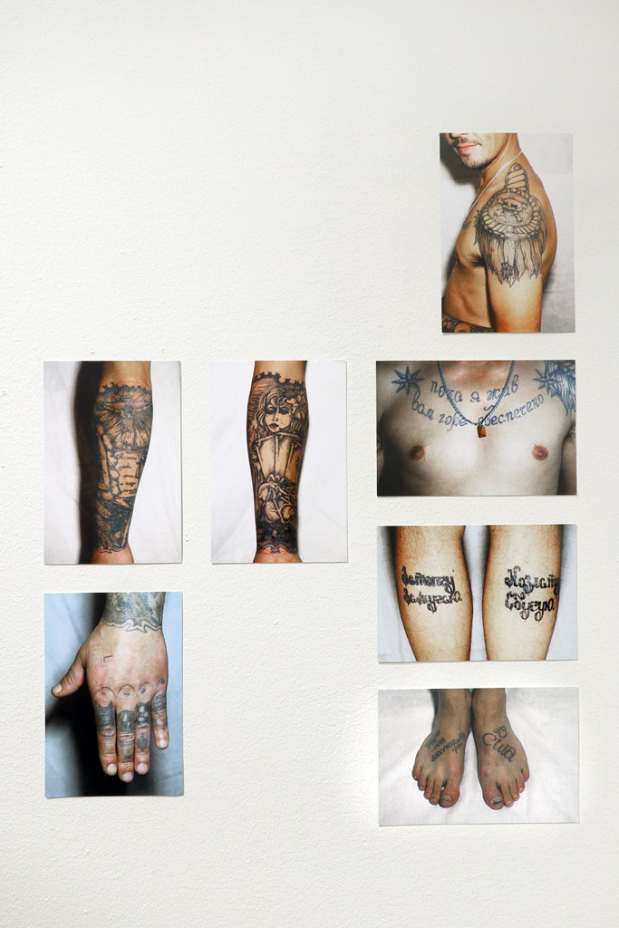 Photographs of tattooed body parts, like hand, feet, shoulder of a man