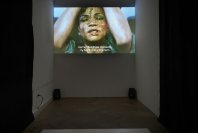 Filmausschnitt einer Frau, die eine Ananas über ihrem Gesicht zerdrückt