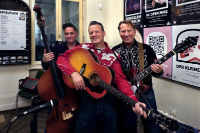 The artists with their instruments, guitars and double bass.