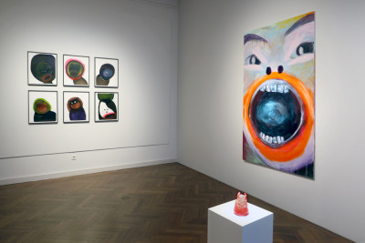 One large and six smaller pictures, with emotional faces hang on the walls.