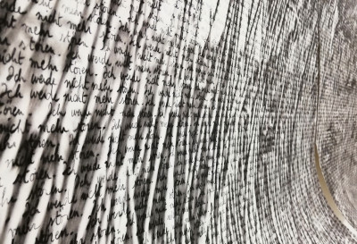 Black writing on cut paper