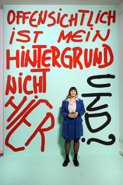 Large light blue poster with red and black lettering: 