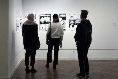 Visitors look at the comic.