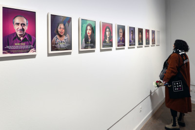 Person looks at the portrait pictures.