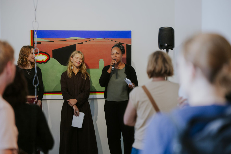 Curator Diana Nowak and gallery director Yolanda Kaddu-Mulindwa stand side by side during the opening of the exhibition nebula at Galerie im Saalbau, addressing the audience.