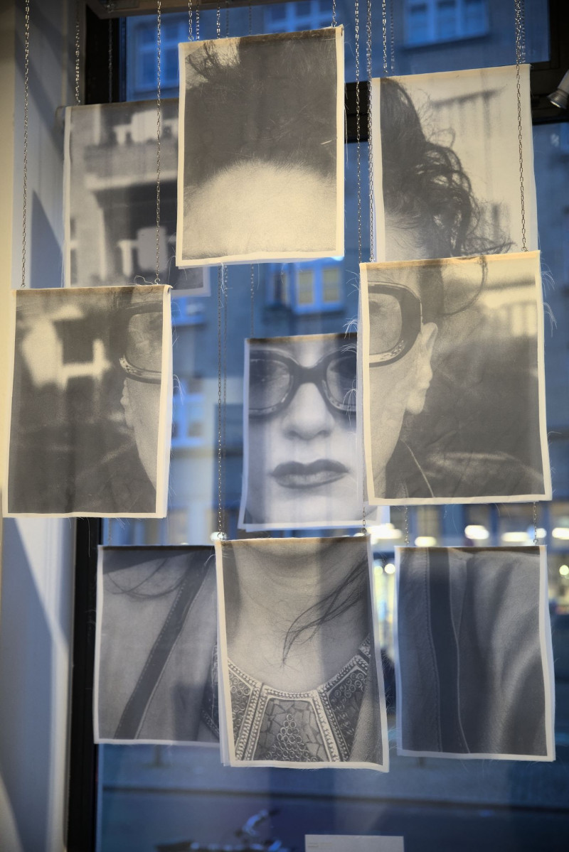 A fragmented portrait of the artist, printed on textile, hangs in the window of the gallery