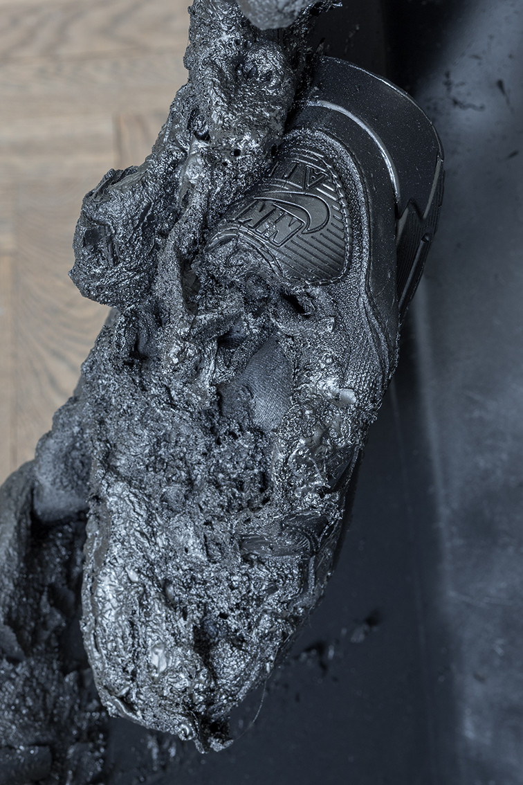 The picture shows a close-up of melted black plastic