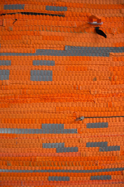 The picture shows an orange-colored woven work.