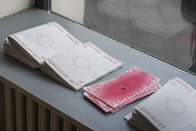 There are exhibition brochures on the windowsill