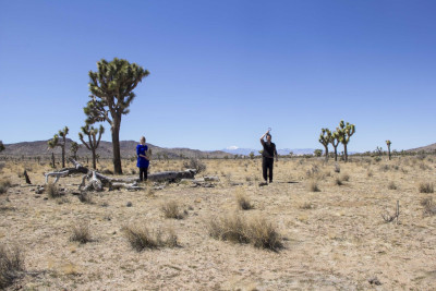 Two people are standing in the desert.